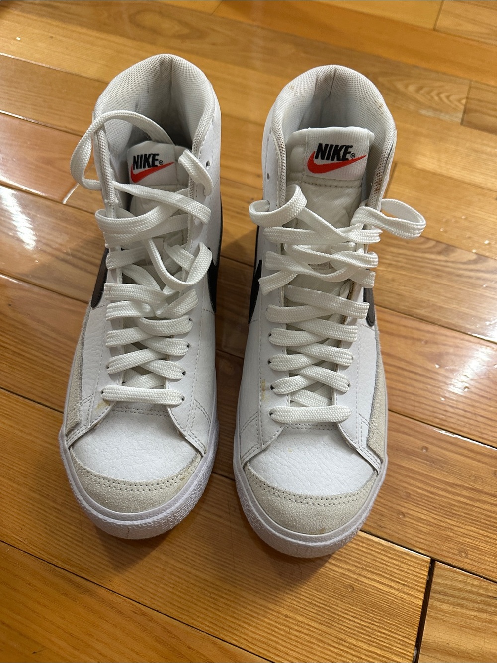 Nike White High-Top Sneakers with Black Swoosh and Red Logo